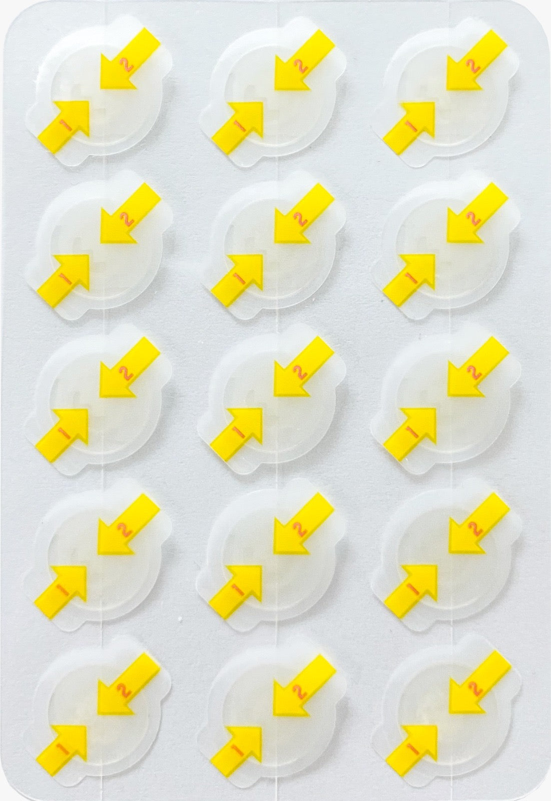 Sheet of 15 clear hydrocolloid acne patches with yellow arrow design numbered 1 and 2 for easy peel and apply touch free application on white background